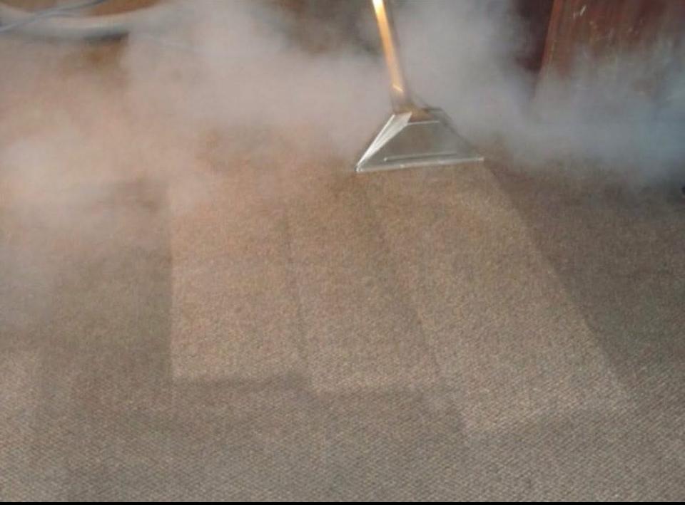 A clean office hallway with patterned carpet.